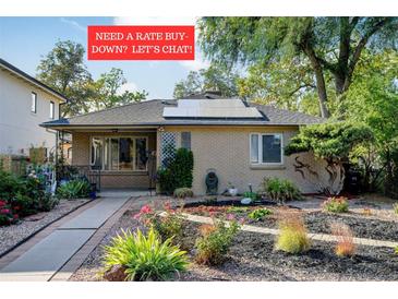 Charming ranch home featuring solar panels and a beautifully landscaped front yard at 1275 Fairfax St, Denver, CO 80220
