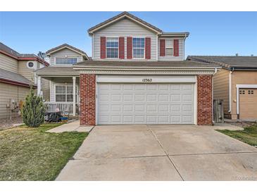 Charming two-story home featuring a large garage and red shutters at 12362 Nate Cir, Parker, CO 80134