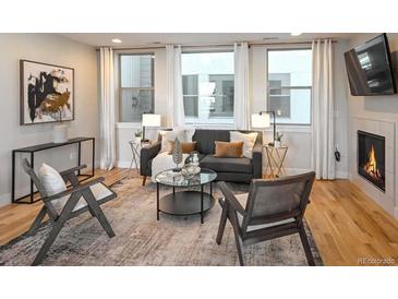 Bright living room with fireplace, hardwood floors, and comfortable seating at 2176 S Birch St, Denver, CO 80222