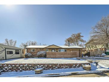 Ranch style home with snow covered yard at 68 W 81St Pl, Denver, CO 80221