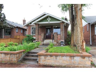 Charming brick home with landscaped front yard and inviting entrance at 1434 Osceola St, Denver, CO 80204