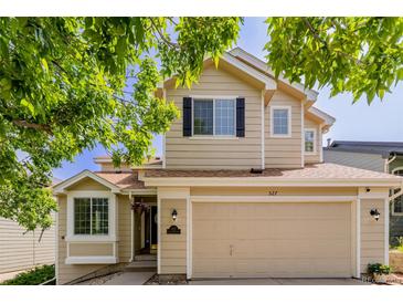 Charming two-story home with a two-car garage, neutral siding, and well-maintained landscaping at 527 English Sparrow Trl, Highlands Ranch, CO 80129