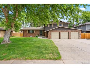 Charming two-story home with a well-manicured lawn and a three car garage at 9043 W Warren Dr, Lakewood, CO 80227