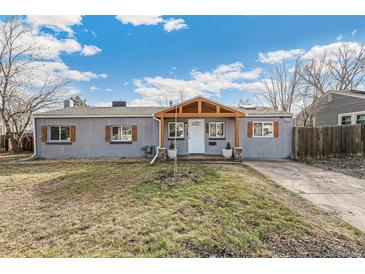 Charming single-story home features a cozy front porch, gray exterior paint, and decorative wooden shutters at 1970 Willow St, Denver, CO 80220