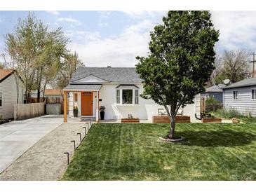 Charming home featuring a manicured lawn, vibrant orange door, and inviting curb appeal at 873 S Raritan St, Denver, CO 80223