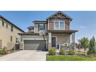 Two-story home with stone accents and a landscaped yard at 15983 E Warner Dr, Denver, CO 80239