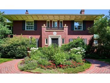 Charming brick home with a manicured front garden featuring a brick walkway at 2215 E 7Th Avenue Pkwy, Denver, CO 80206