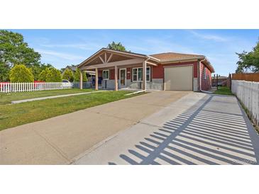 Charming single-story home with covered porch, long driveway, and attached one car garage at 11192 E 7Th Ave, Aurora, CO 80010