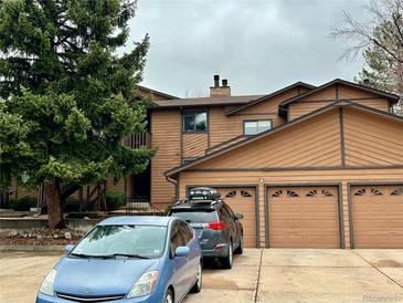 Two-story townhome with a three-car garage and a neatly kept driveway at 9411 W 89Th Cir, Westminster, CO 80021