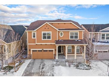 Charming two-story home featuring a two car garage, welcoming front porch and traditional architectural details at 22870 E Chenango Ave, Aurora, CO 80015