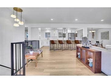 Spacious open-concept living and kitchen area with modern finishes and ample natural light at 6909 S Clermont St, Centennial, CO 80122