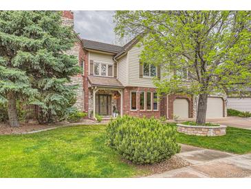 Charming two-story home with a well-maintained lawn and brick and stone accents at 5390 S Geneva St, Englewood, CO 80111