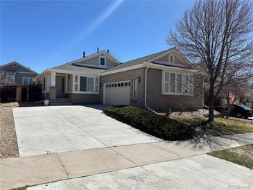 Charming single-story home with brick accents, attached garage, and well-maintained front yard at 20148 E Dartmouth Dr, Aurora, CO 80013