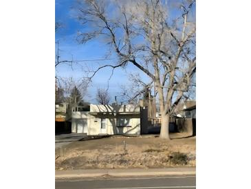 Single story home with simple landscaping and a mature tree in the front yard at 4445 E Florida Ave, Denver, CO 80222