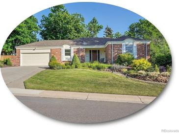 Charming one-story brick home featuring a well-manicured lawn and an attached two-car garage at 6844 S Detroit Cir, Centennial, CO 80122