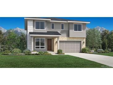 Inviting two-story home featuring stone accents, neutral siding, a two-car garage, and a well-manicured lawn at 318 Welded Tuff Trl, Castle Rock, CO 80104