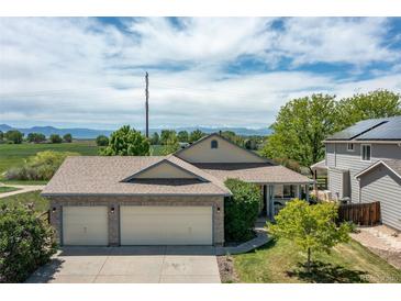 Charming single-Gathering home with a spacious three-car garage and mountain views in the background at 1264 Banner Cir, Erie, CO 80516