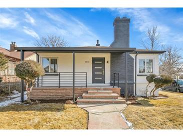 Charming home featuring brick accents, a covered porch, and well-maintained landscaping at 2800 Albion St, Denver, CO 80207