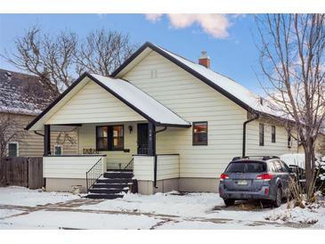 Cute bungalow style home with front porch and mature trees at 141 N 5Th Ave, Brighton, CO 80601