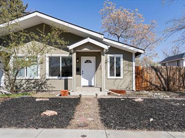 Charming home featuring a manicured front yard, quaint walkway, and stylish front door at 2850 Lowell Blvd, Denver, CO 80211