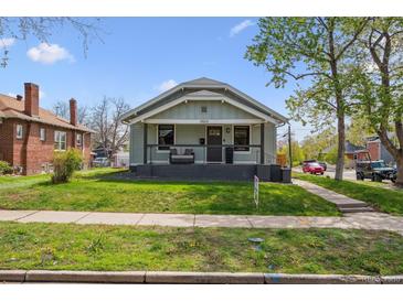 Charming home with a covered front porch and well-maintained lawn and garden and walkway at 4504 N Clay St, Denver, CO 80211