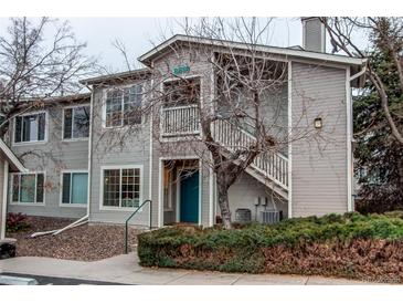 Inviting two-story home with a blue front door and a well-kept exterior at 8416 Pebble Creek Way # 203, Highlands Ranch, CO 80126