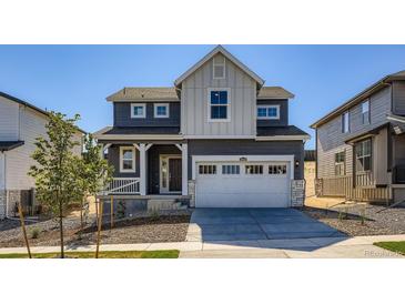 Charming two-story home featuring a two-car garage, inviting porch, and modern architectural details at 10968 Snowdon St, Parker, CO 80134