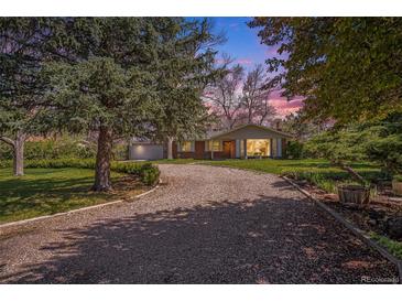 Charming brick home with mature trees, large front yard, and private driveway at 10490 W 78Th Ave, Arvada, CO 80005