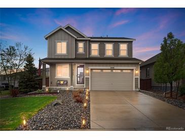 Charming two-story home with a well-manicured lawn, a covered porch, and a two-car garage at 16400 Alberta Dr, Parker, CO 80134