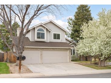 Charming two-story home featuring a three-car garage, mature trees and inviting curb appeal at 3205 S Tulare Ct, Denver, CO 80231