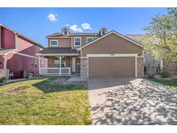 Charming two-story home featuring a covered porch, stone accents, and a well-maintained front yard with mature tree at 11748 Mill Valley St, Parker, CO 80138