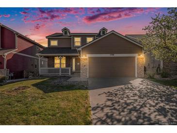Charming two-story home with a spacious front yard and a two-car garage with stone details at 11748 Mill Valley St, Parker, CO 80138