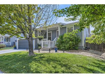 Charming home featuring a well-maintained lawn, gravel landscaping, and a lovely front porch at 537 N 48Th Ave, Brighton, CO 80601