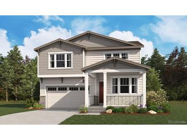 Charming two-story home featuring a covered porch and a two-car garage at 465 S Salida St, Aurora, CO 80017