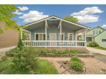 Charming blue bungalow features a covered porch, updated landscaping and a basketball hoop at 280 Pierce St, Erie, CO 80516