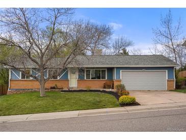 Charming single-story home with a well-manicured front yard and a two car garage at 7282 S Vance St, Littleton, CO 80128