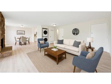 Bright living room featuring a decorative fireplace, modern furniture, and an adjacent dining area at 3365 Chisholm Trl # B102, Boulder, CO 80301