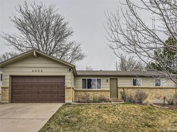 Charming single-story home featuring a well-manicured lawn, brick accents, and a two-car attached garage at 4665 E Peakview Ave, Centennial, CO 80121