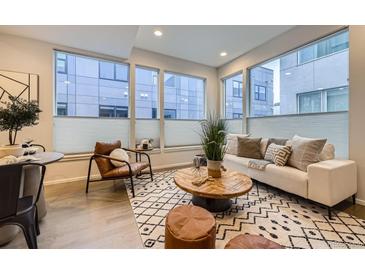 Bright living room features large windows, modern furniture, and stylish decor at 3256 Federal Blvd, Denver, CO 80211