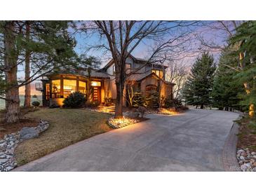 Charming two-story home featuring beautiful curb appeal, a concrete driveway and mature landscaping at 2 Twin Flower, Littleton, CO 80127