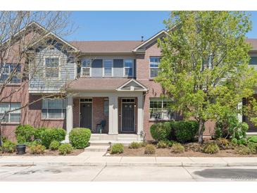 Charming brick townhome featuring a welcoming front porch and well-maintained landscaping at 7440 E 8Th Ave # 25, Denver, CO 80230