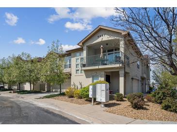 Inviting condo showcasing private balcony, desert landscaping, and attached garage at 6687 S Forest Way # E, Centennial, CO 80121