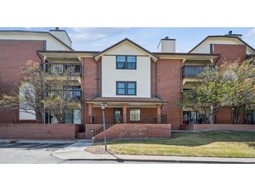 Inviting exterior view of the multi-story condo with brick accents and an outdoor porch at 13950 E Oxford Pl # B105, Aurora, CO 80014