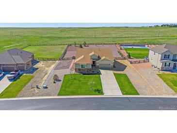 A beautiful home featuring a large lawn, spacious driveway, and a fenced backyard at 42073 Colonial Trl, Elizabeth, CO 80107