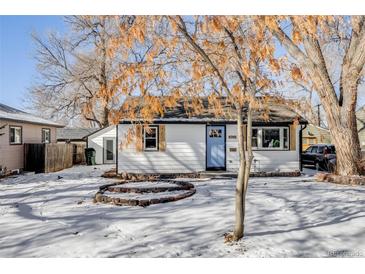 Charming remodeled home with a light blue door and snow-covered yard at 4745 S Sherman St, Englewood, CO 80113