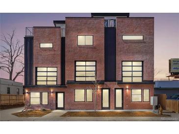 Modern brick townhome featuring large windows and sleek black accents creating curb appeal at 1473 N Locust, Denver, CO 80220