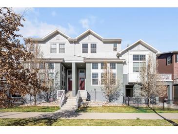 Beautiful townhome featuring inviting entry, charming curb appeal, and low-maintenance landscaping at 2366 Central Park Blvd, Denver, CO 80238