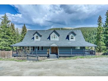 Charming two-story home with a covered porch nestled among mature trees at 234 Carroll Ln, Breckenridge, CO 80424