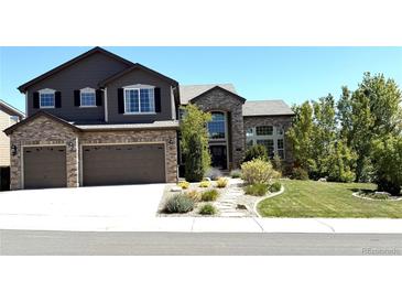 Beautiful two story home showcasing a well-manicured yard and attached two car garage at 7408 Sodalite Way, Castle Rock, CO 80108