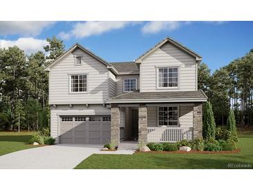 Charming two-story home with stone accents, a covered porch, and a well-manicured front yard at 730 Lawson Dr, Elizabeth, CO 80107